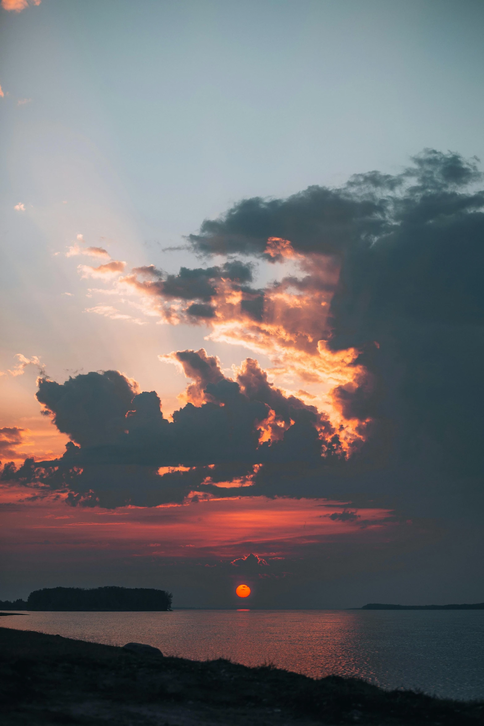 clouds in the sky over water at sunset