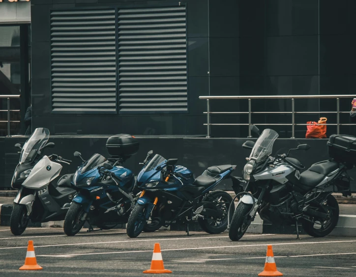 there are many motorcycles parked by the fence