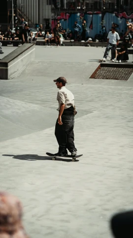 a person riding a skateboard in a concrete area