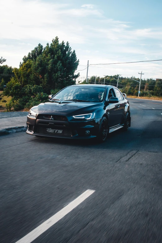 a black car driving down the road