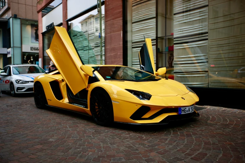 a yellow sports car is parked outside of a store