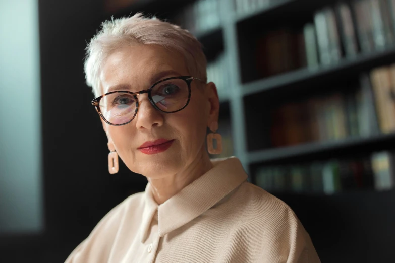 an older woman in a liry wearing glasses