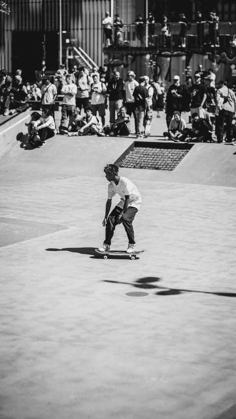 man riding on a skateboard in an empty skate park