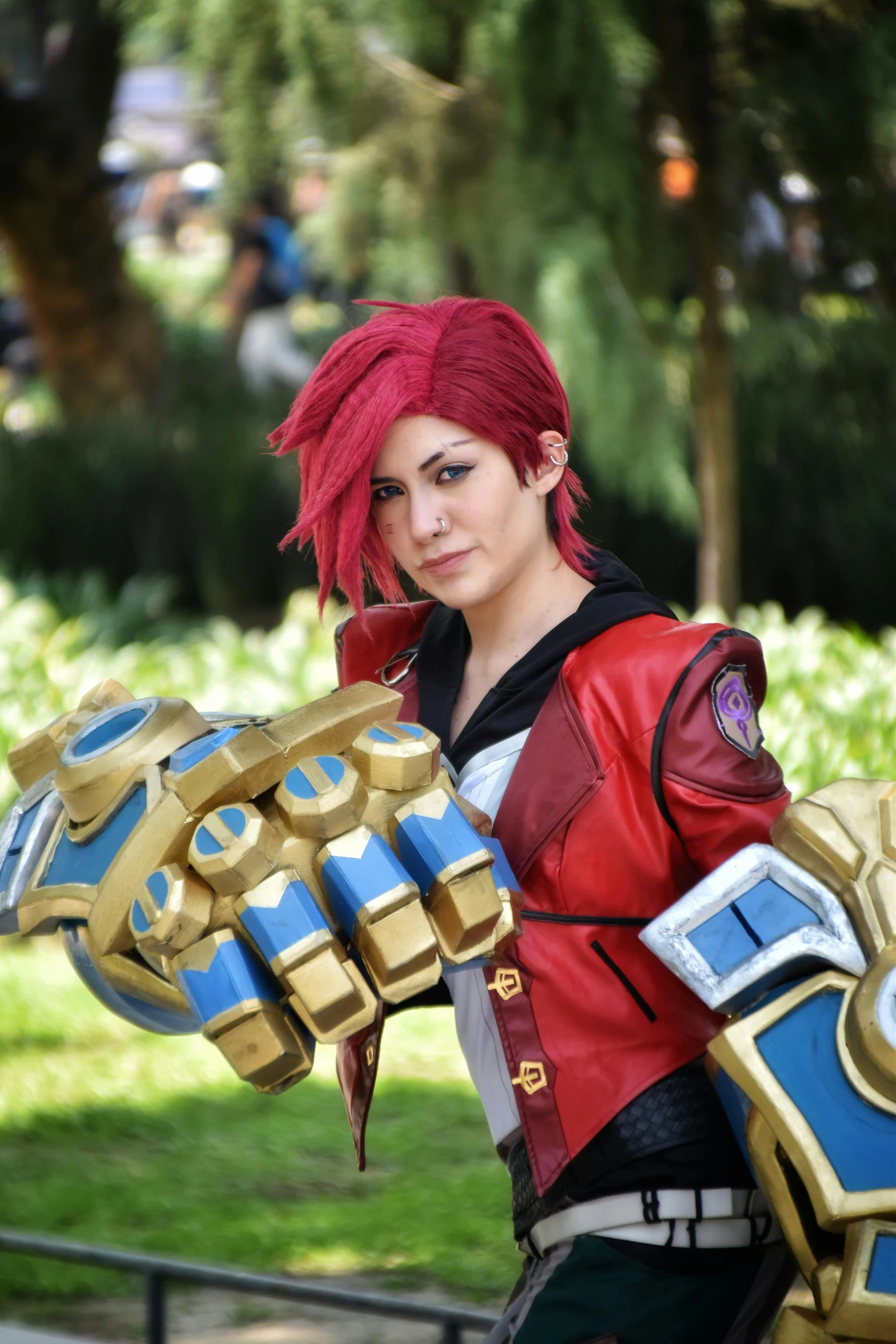 a female with red hair holding a large gold item