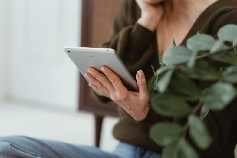 a close up of a woman using a tablet