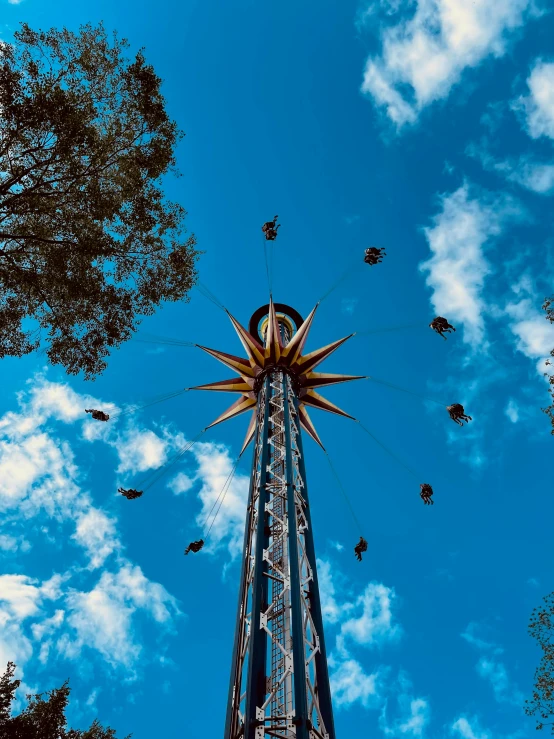 a very tall tower that has a bird flying overhead