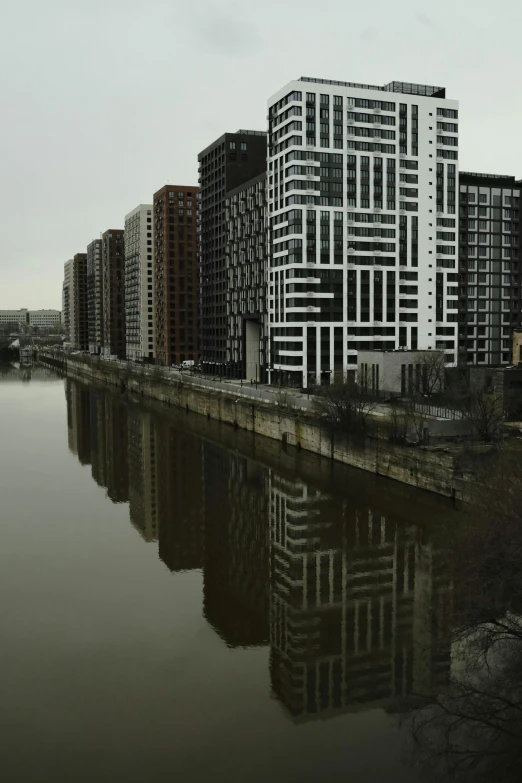 the building is next to the water with its reflection in the water