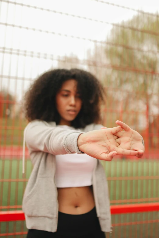 the girl is showing off her hand gesture