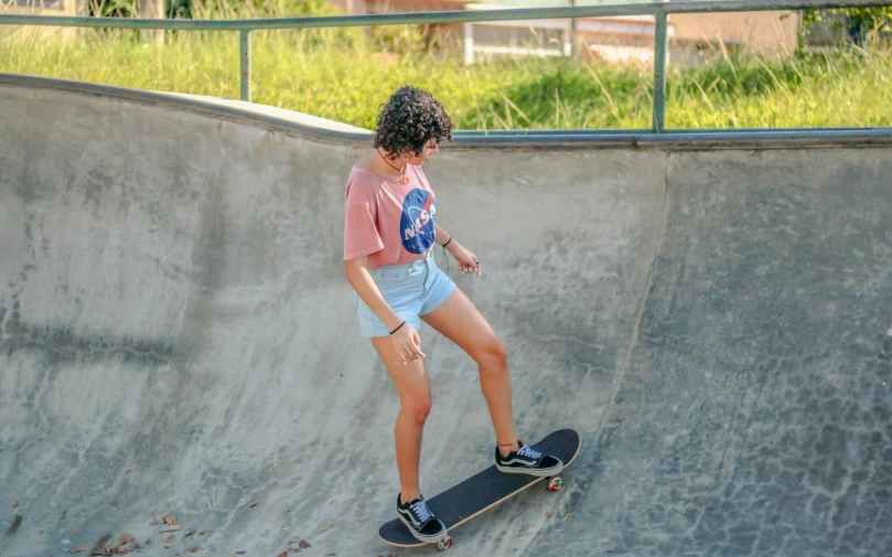 a young man riding up the side of a skate board ramp
