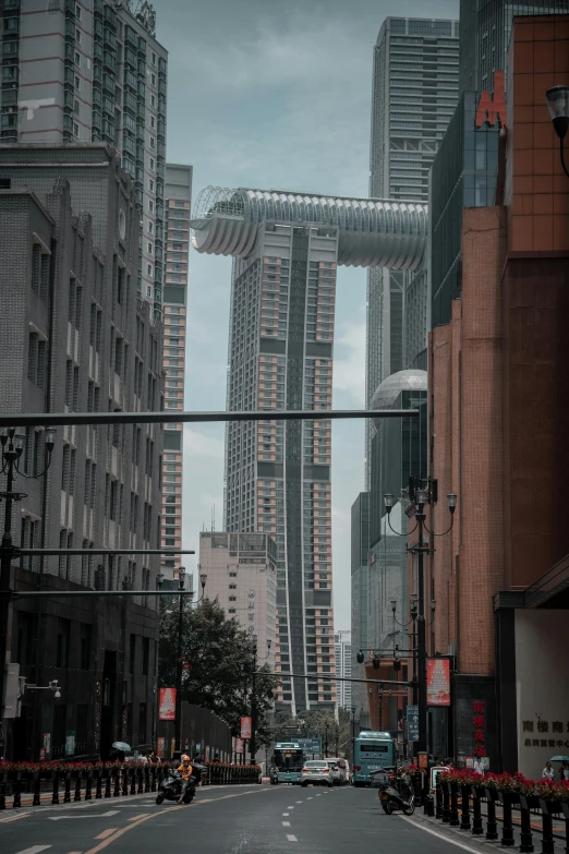 a city road with traffic lights and a group of tall buildings in the background