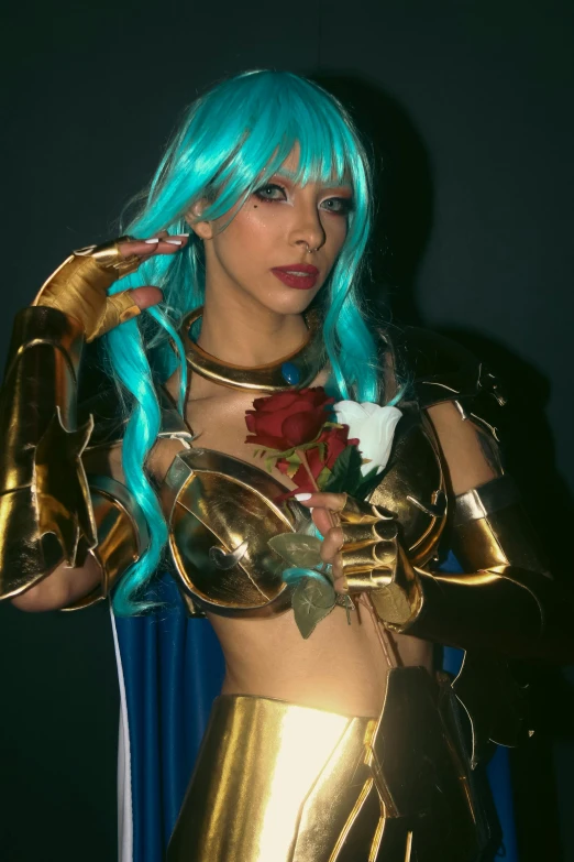 this is a woman wearing a gold outfit and turquoise hair