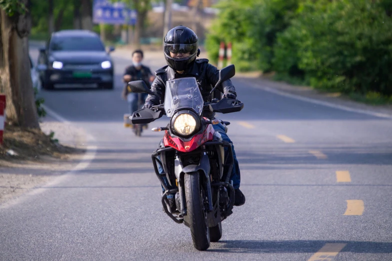 man on a motor bike traveling down the street