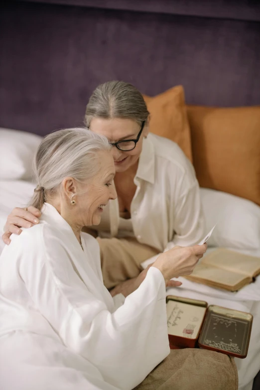 a man and woman that are sitting on a bed