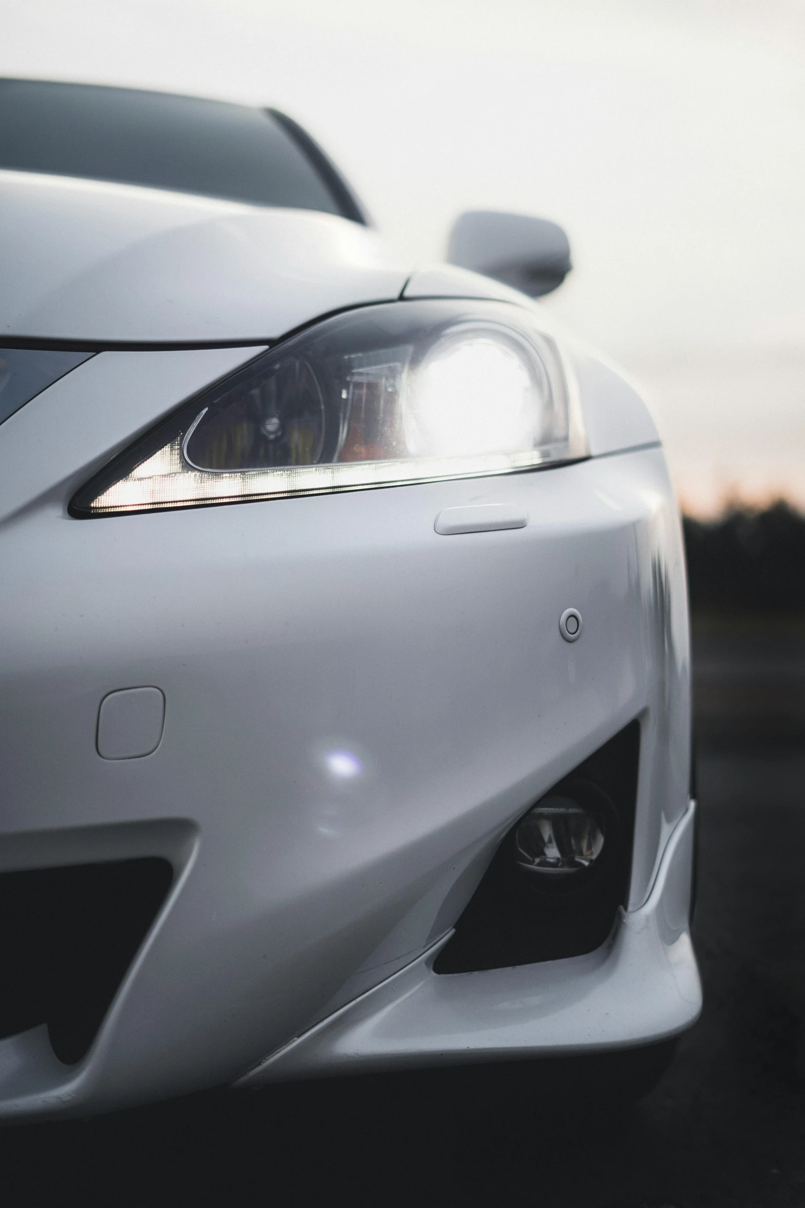 a close up view of the front of a silver sports car