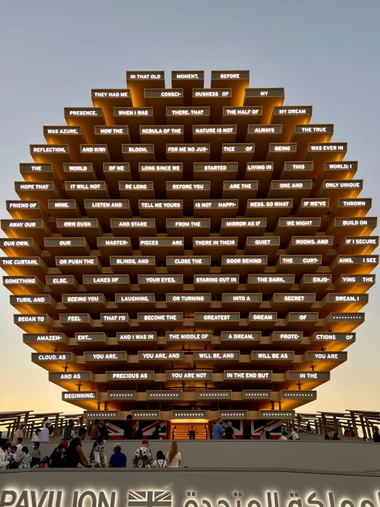 a big structure with a bunch of people sitting outside