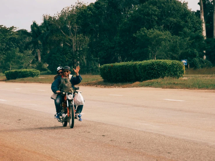 two people riding a motorcycle with the back of them