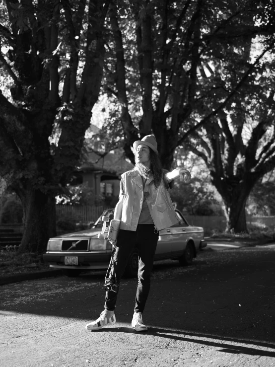 a woman walking down the street in black and white