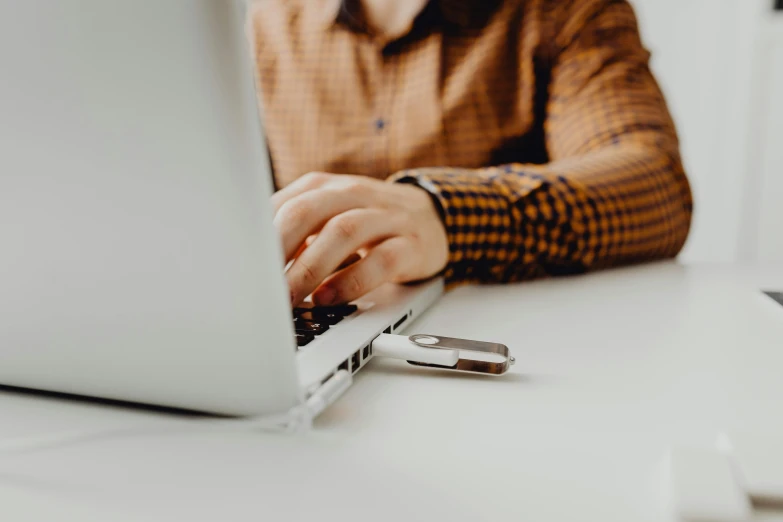 a man is working on his laptop at a desk