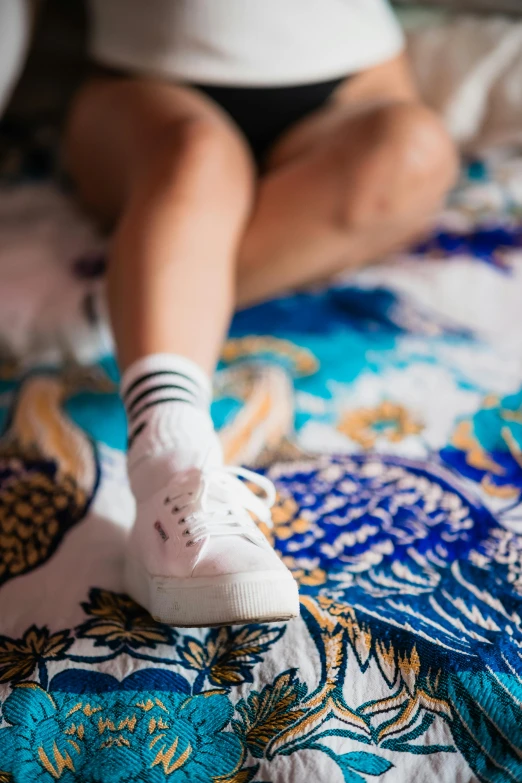 someone with their feet in the air on a bed