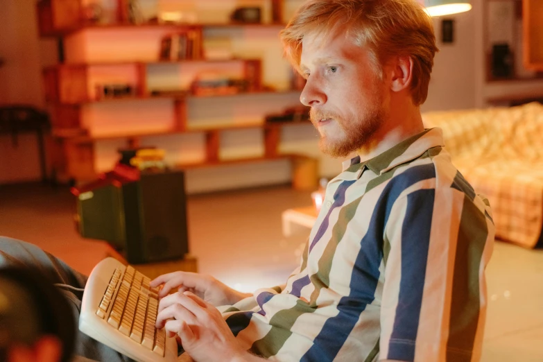 a man is using a keyboard to use the computer