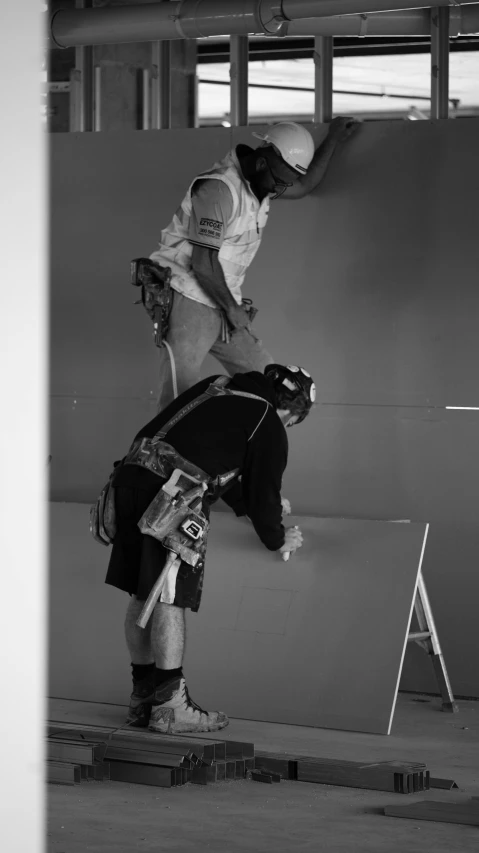 two young men playing on an indoor skateboard ramp