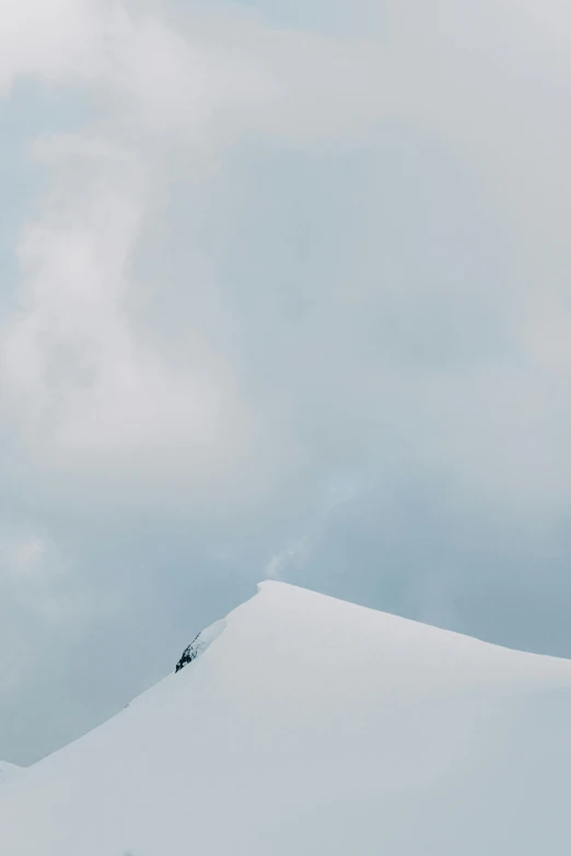 two people climbing up the side of a mountain