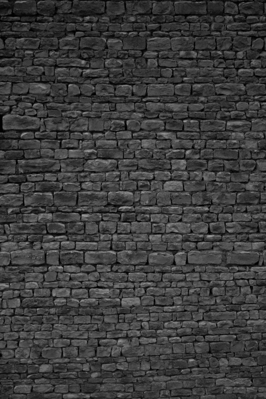 black brick wall with a small yellow patch