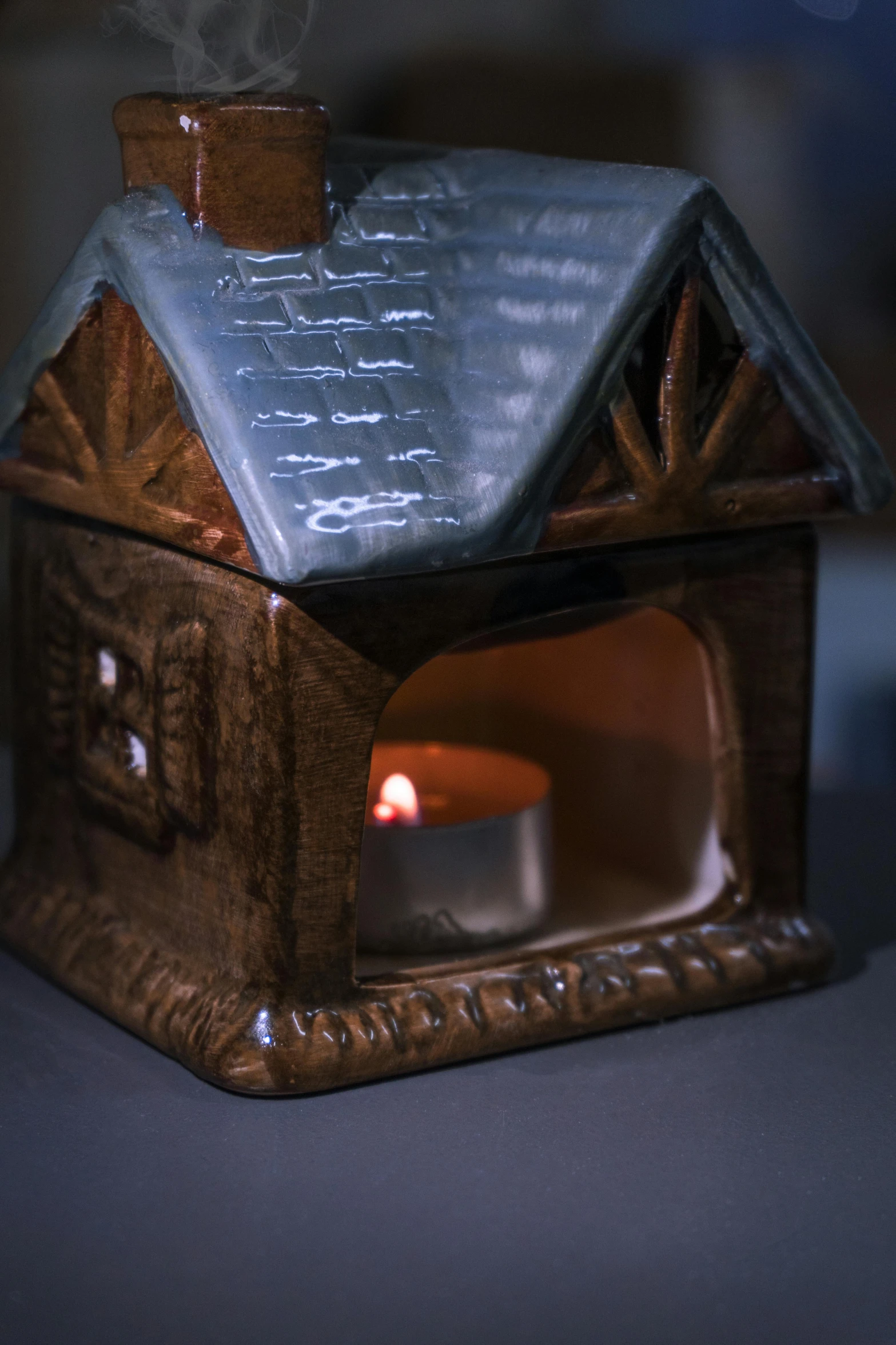 a lit candle and a candle holder in a house