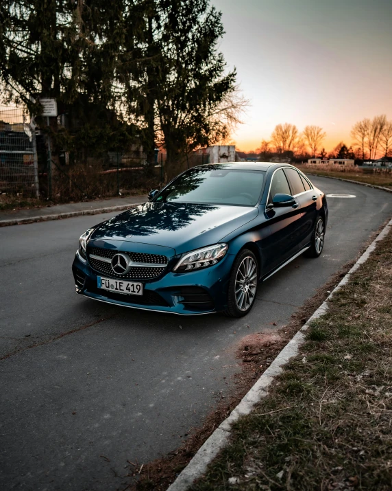 a blue mercedes benz cls parked on the side of the road