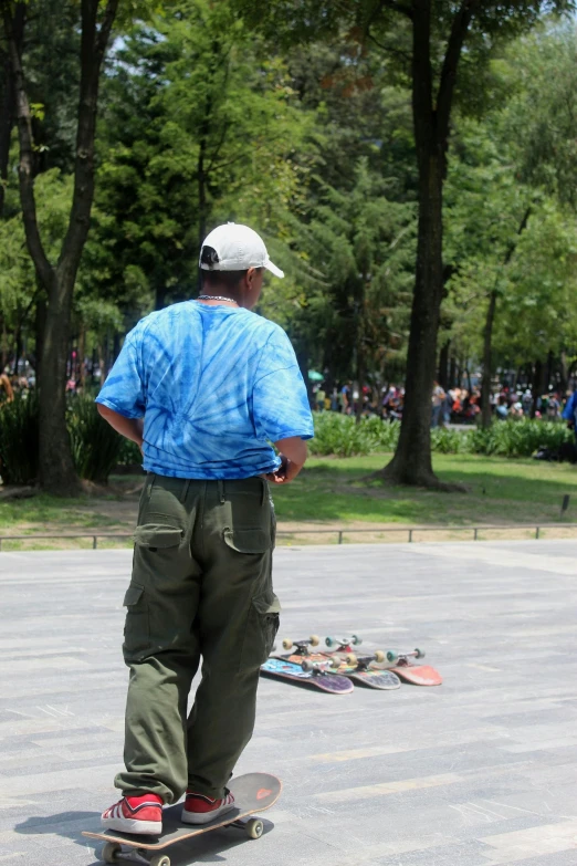 a man stands on a skateboard while looking over his shoulder