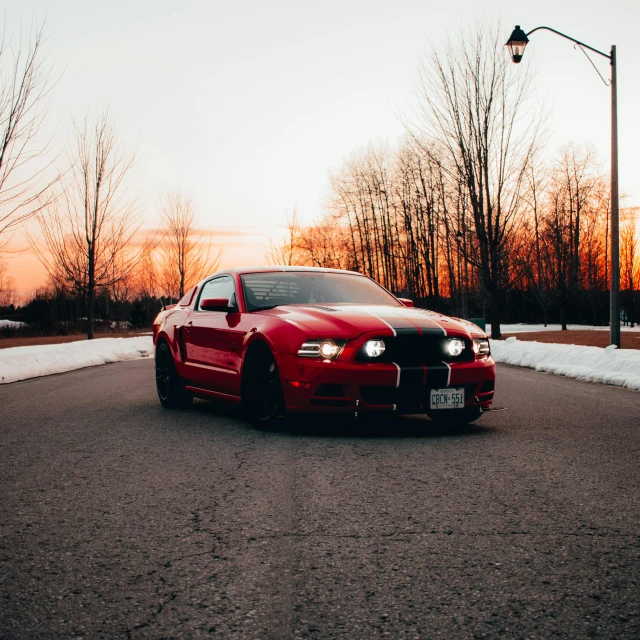 a red sports car is parked in the driveway