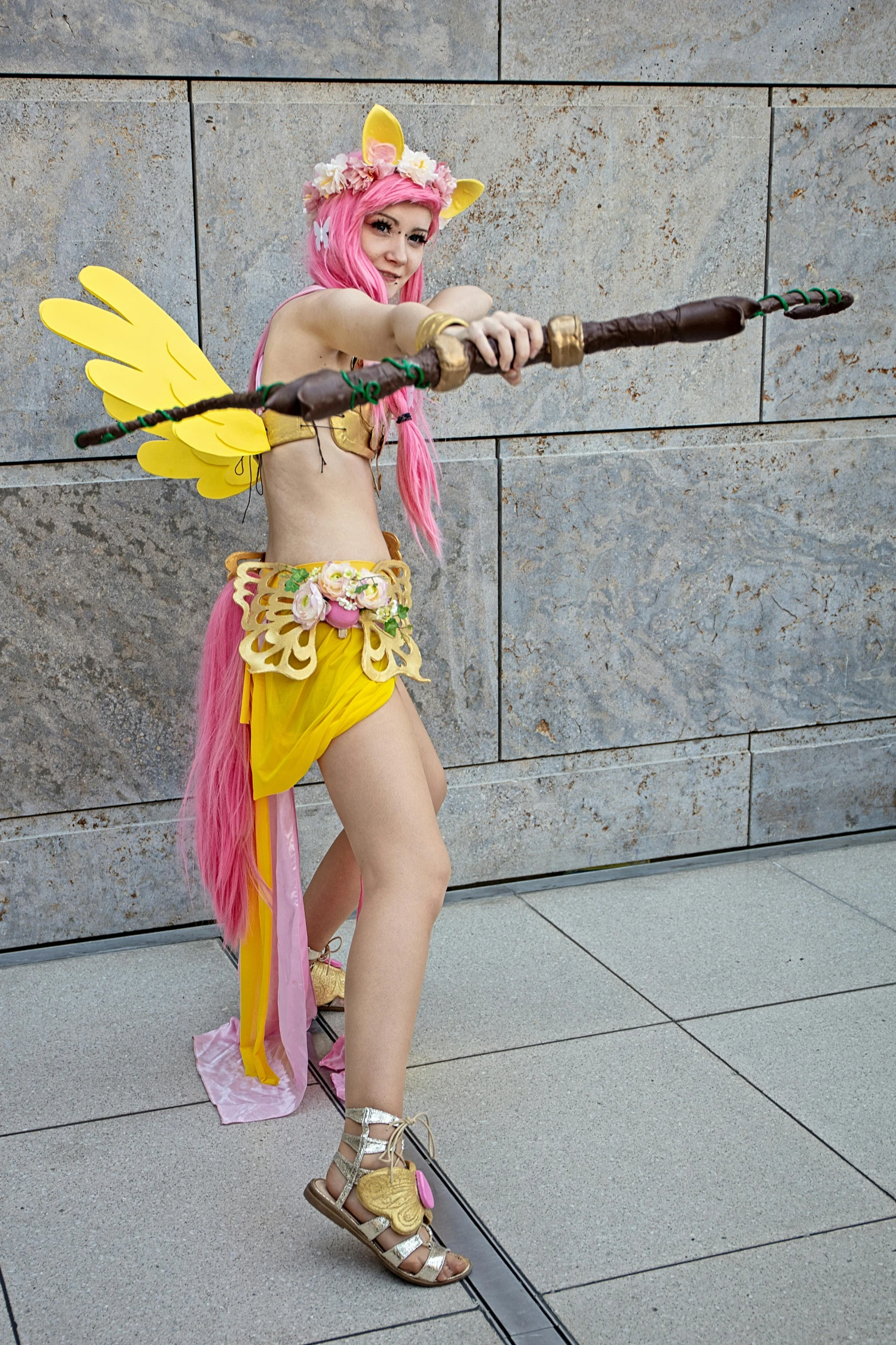 a women that is standing on a pole with a baseball bat