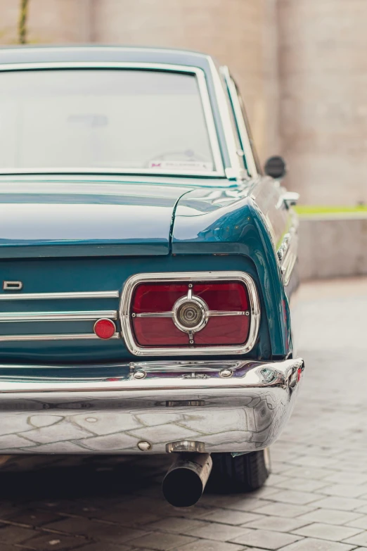 the rear end of a blue and white car