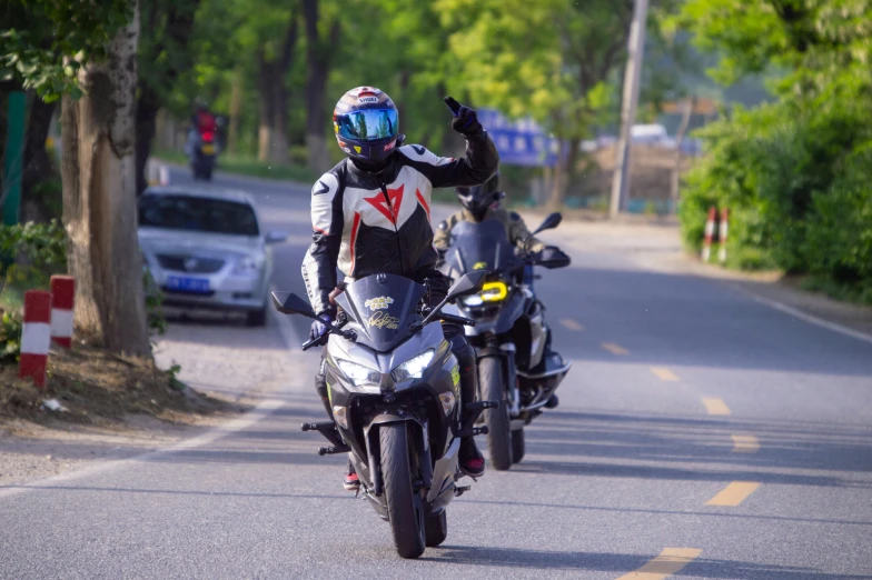 a motorcycle rider wearing a helmet is on the street