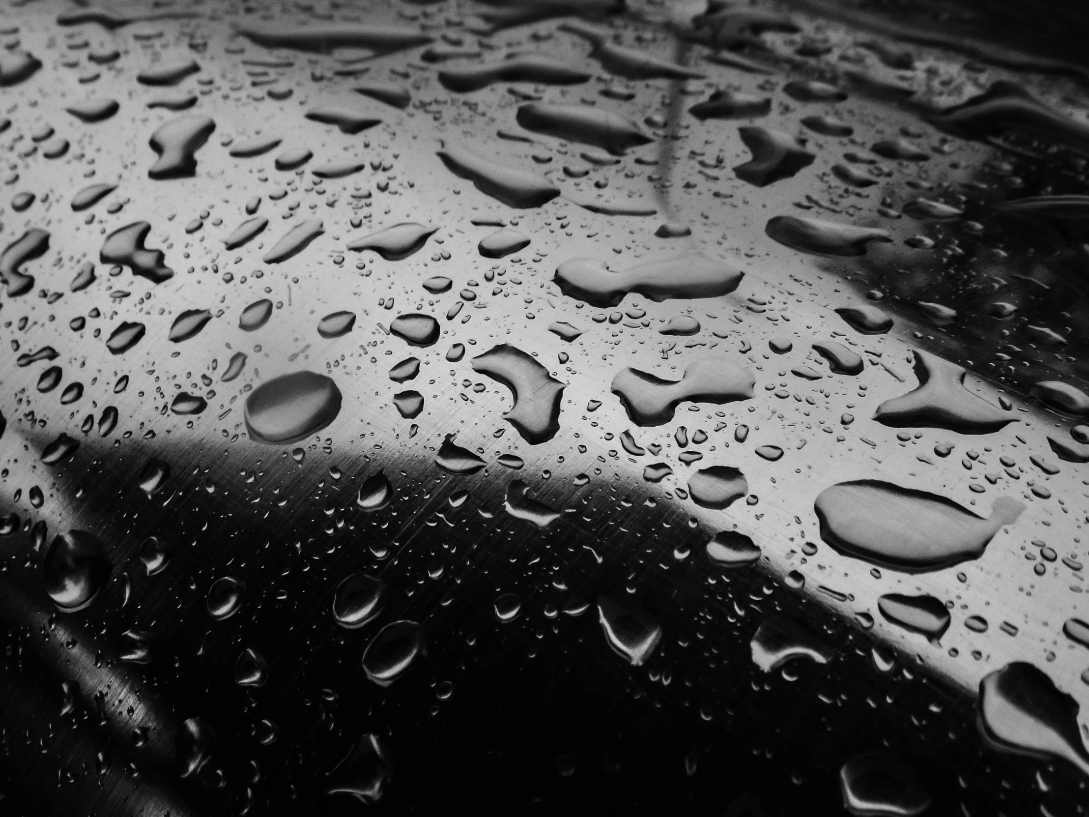 a black and white po of raindrops on the car