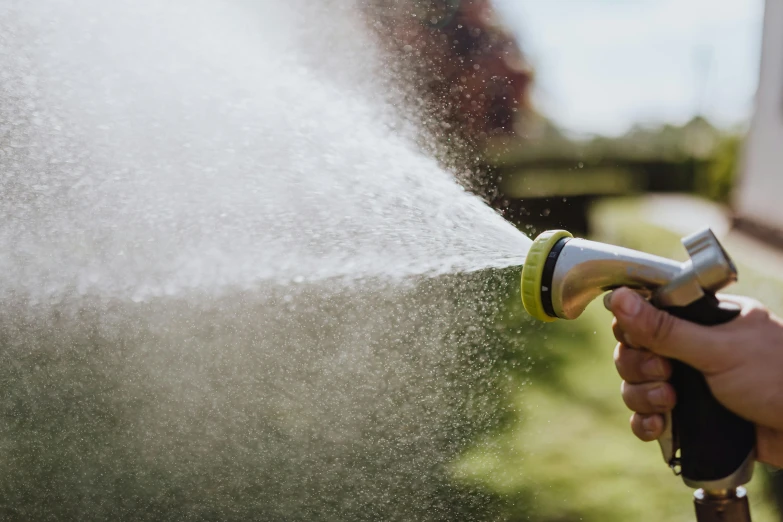 a person spraying water with an open handle