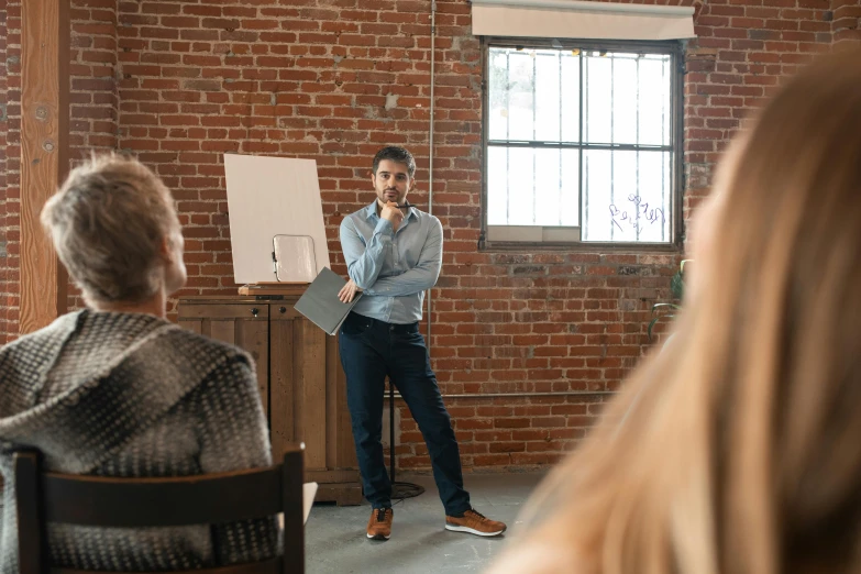 a man is standing by a podium and giving a presentation