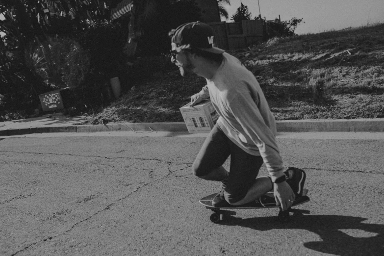 a man riding his skateboard on the road