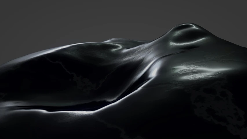 a black object with water that looks like a wave