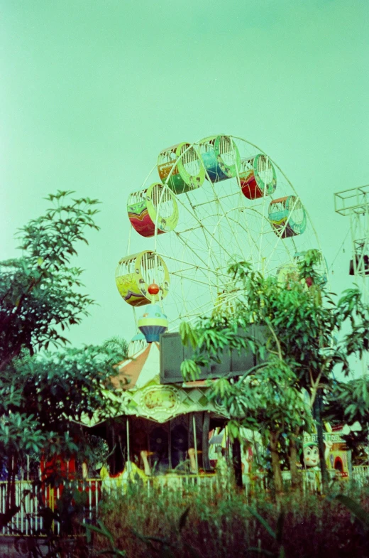 an old ferris wheel is pictured against a blue sky