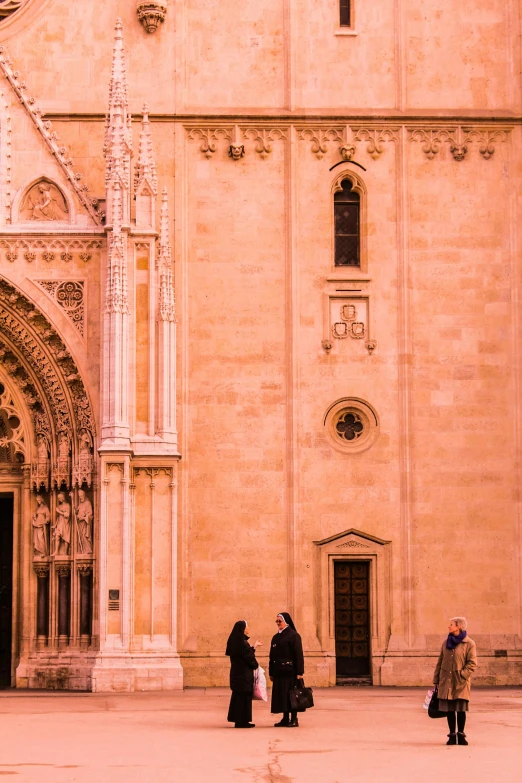 some people are standing in front of an old church