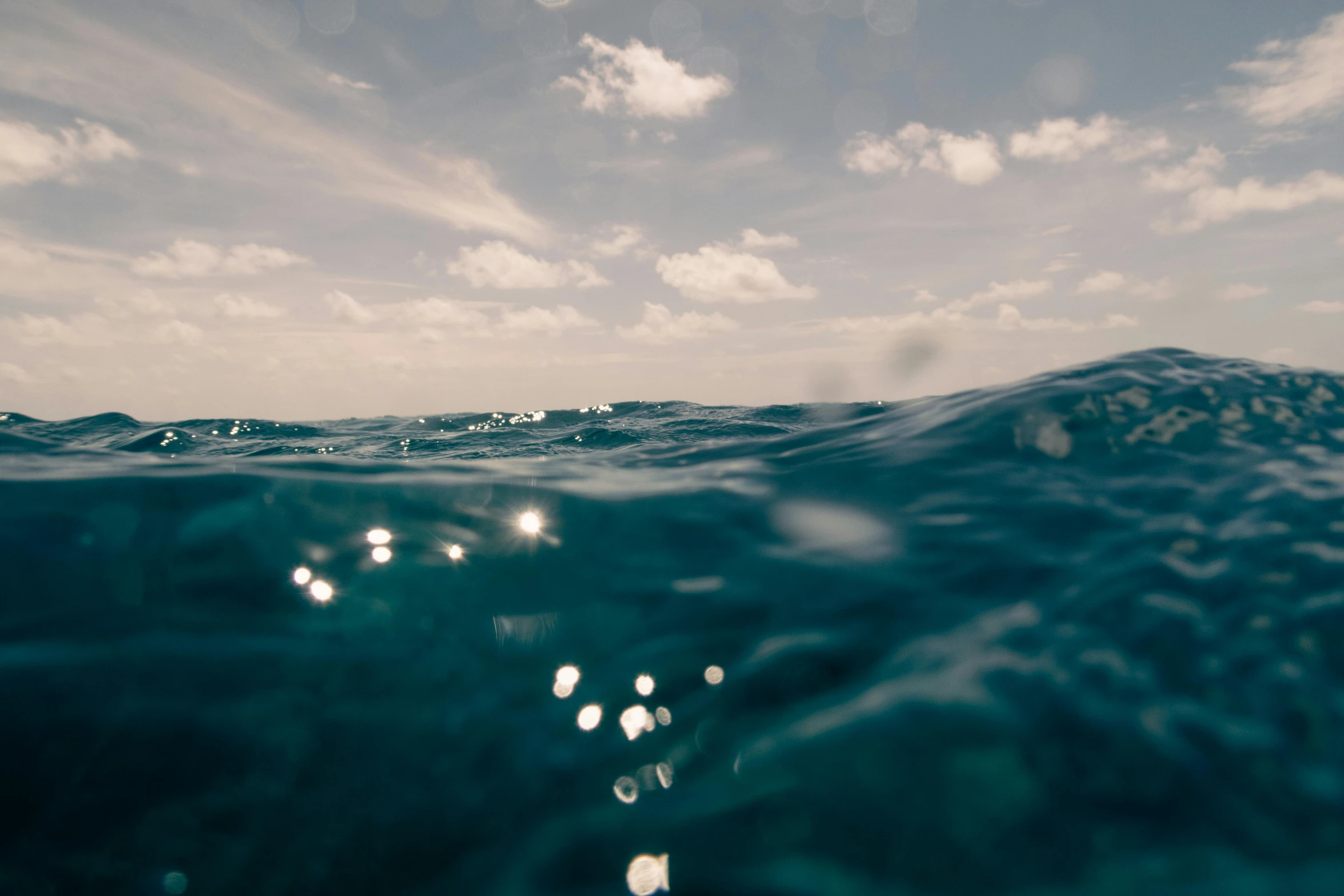 the water is crystal blue with white clouds