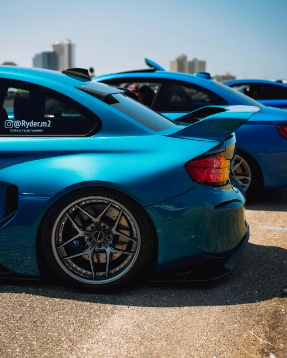 there is a blue sports car that is parked in the lot