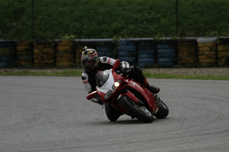 the man is racing the motorcycle down the road