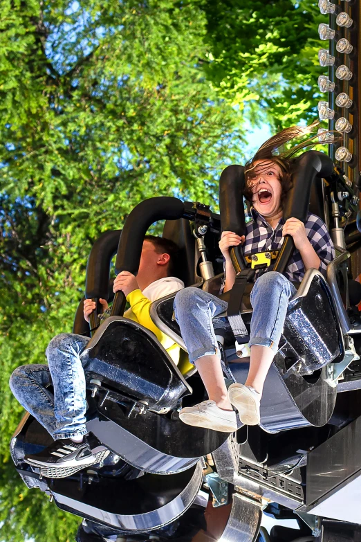 a boy in a helmet is on a roller coaster