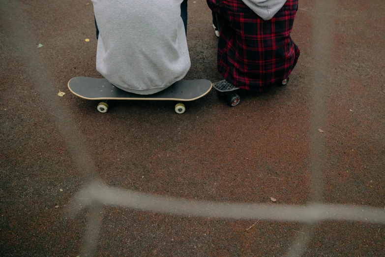 two people with one riding a skateboard