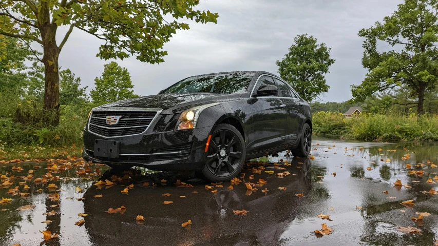 a car parked on a road in the rain