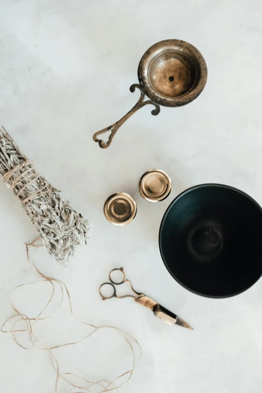 an assortment of supplies from a jewelry store including scissors and a bowl