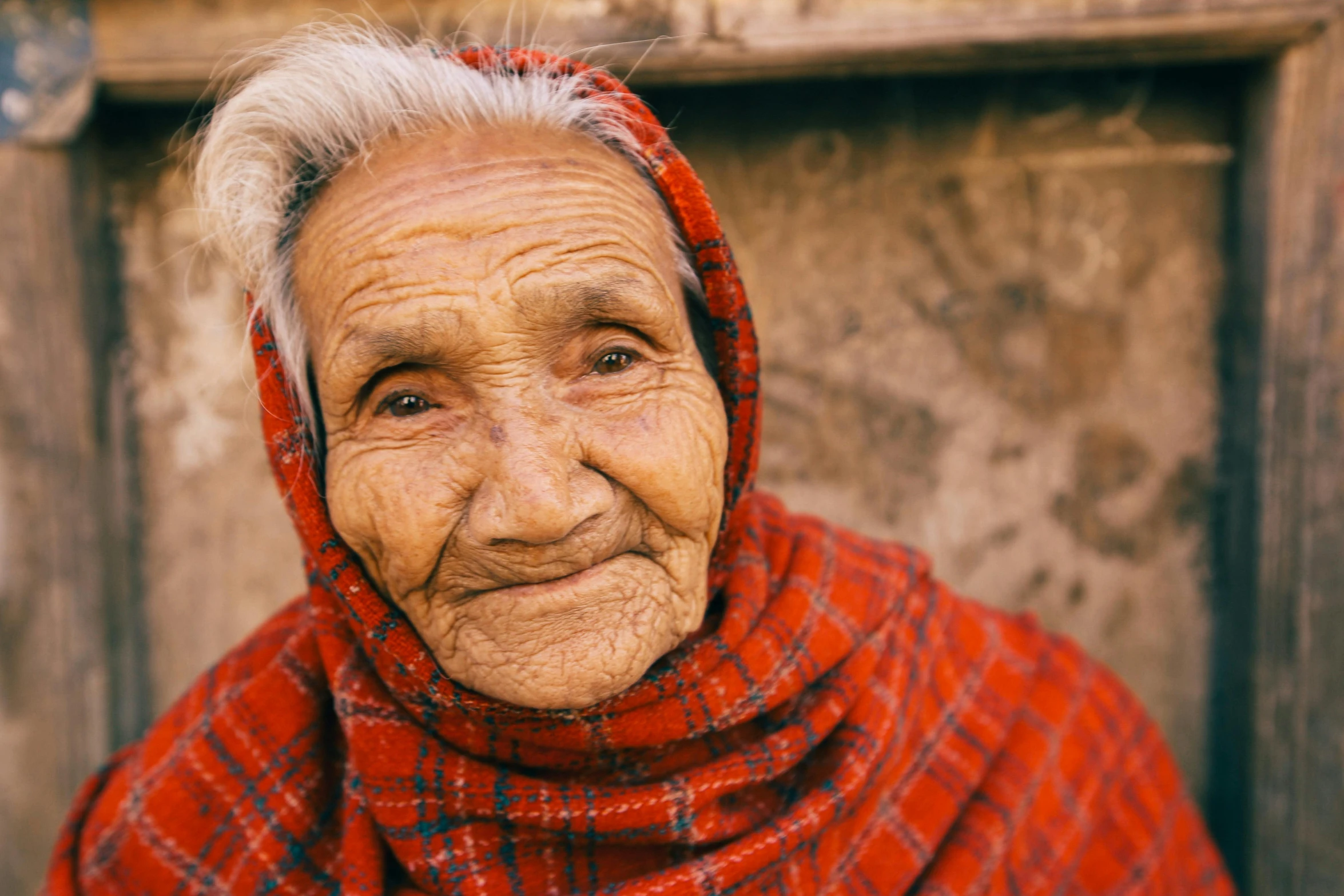 an old woman with a white face and a red hood on