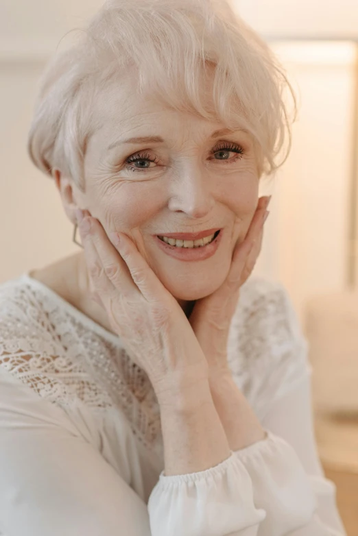 an older woman posing with her chin resting on her hand